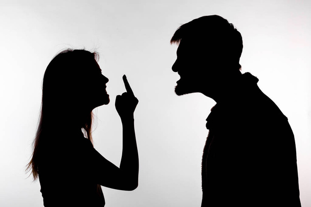 Aggression and abuse concept - man and woman expressing domestic violence in studio silhouette isolated on white background. - Fotografie, Obrázek