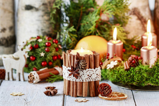 Candle decorated with cinnamon sticks - Photo, image