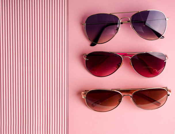 pink sunglasses on background with copy space, space for text, concept minimalism and modern style - Photo, Image