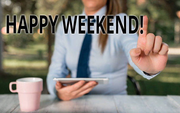 Conceptual hand writing showing Happy Weekend. Business photo text something nice has happened or they feel satisfied with life Female business person sitting by table and holding mobile phone. - Photo, Image