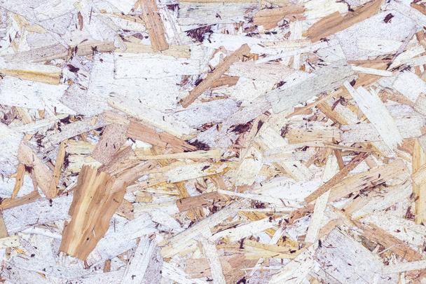wood texture background. pressed sawdust. OSB boards are made of wood chips. Top view of OSB wood veneer background - Foto, afbeelding