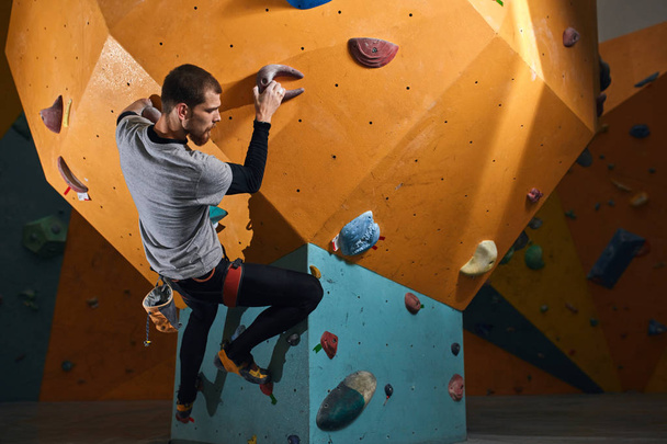 Man with physical disability rock climbing during his morning training - Photo, Image