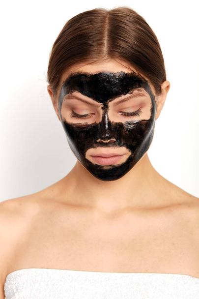 young woman with nourishing mask looking down - Photo, Image