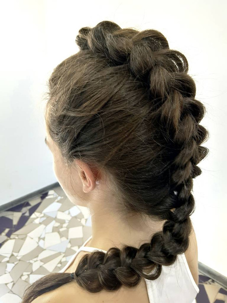 Hairstyle on long hair, braiding a fishtail - Photo, Image