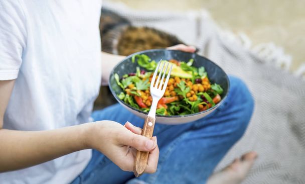 Clean eating, vegan healthy salad bowl closeup , woman holding s - Фото, изображение