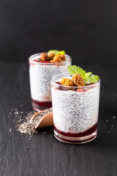 Healthy food concept Chia seeds, milk pudding with goji, white m - Photo, Image