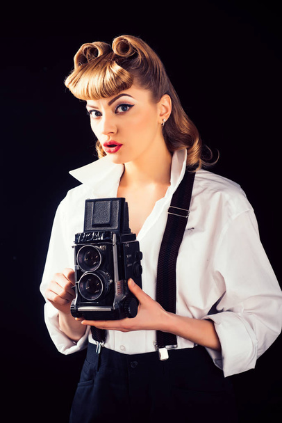 Retro vintage concept. Beautiful woman holding a camera. Old style. The best moments of life on film. - Фото, изображение