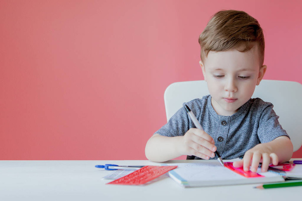 Portrait of cute kid boy at home making homework. Little concent - Foto, Imagem