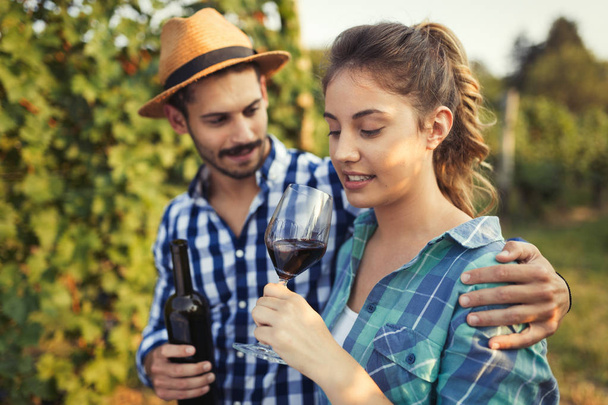 Couple in love working at winemaker vineyard - Foto, imagen