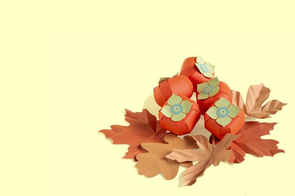Paper persimmon and autumn leaves  - Photo, Image