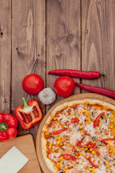 Pizza and red wine on wooden table background. Top view with copy space - Foto, Imagem