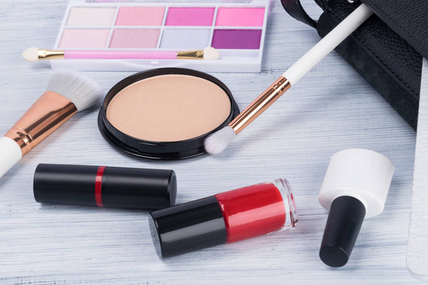 various makeup items and accessories from a womans handbag are scattered - Photo, image