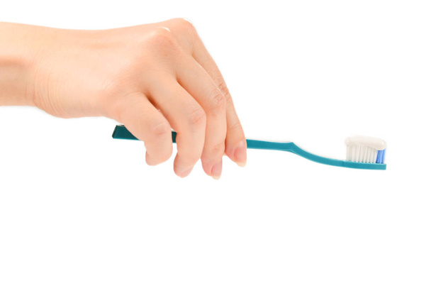 Woman holds toothbrush with toothpaste in her hand isolated on w - Zdjęcie, obraz