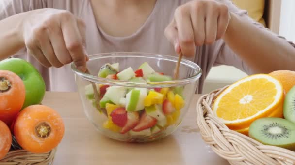 Close-up beelden van de vrouw die fruitsalade bereidt - Video