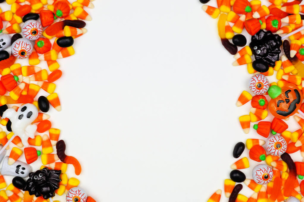 Halloween candy double side border. Top view on a white background with copy space. - 写真・画像