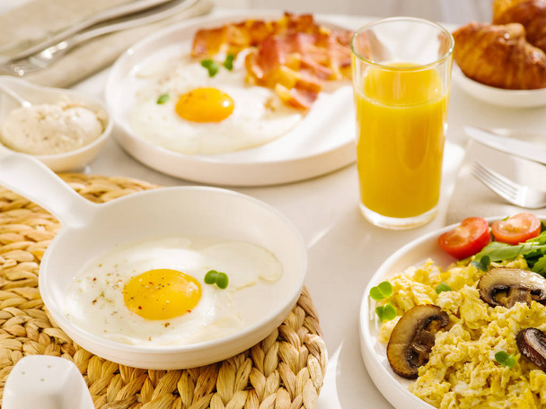 Morning breakfast with egg, bacon and orange juice. Fried eggs s - Photo, Image