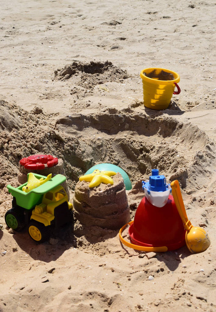 Children's beach toys on sand on a sunny day. - Fotó, kép