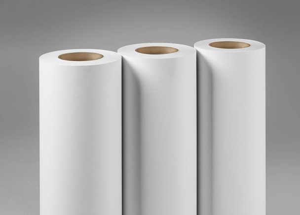 Blank white paper rolls mockup isolated on gray background - Foto, afbeelding