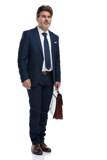 Anxious businessman holding his briefcase and thinking - Photo, Image