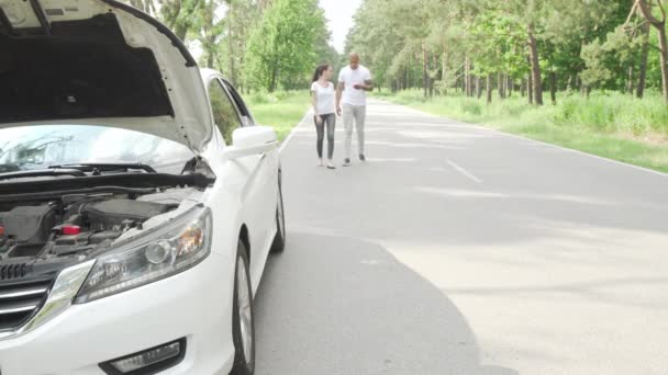 Para czeka na samochód holowniczy na drogach wiejskich - Materiał filmowy, wideo