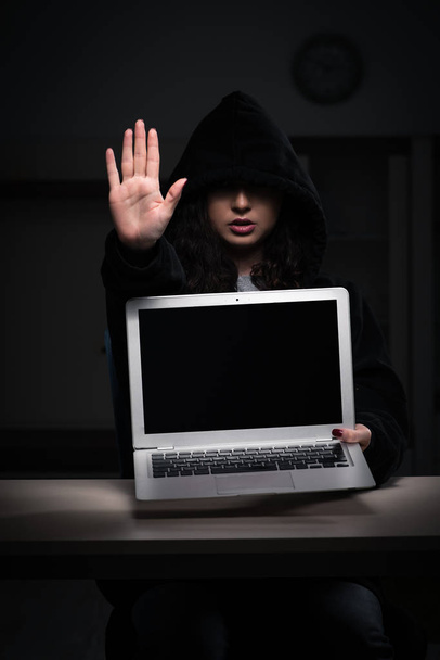 Female hacker hacking security firewall late in office  - Photo, Image