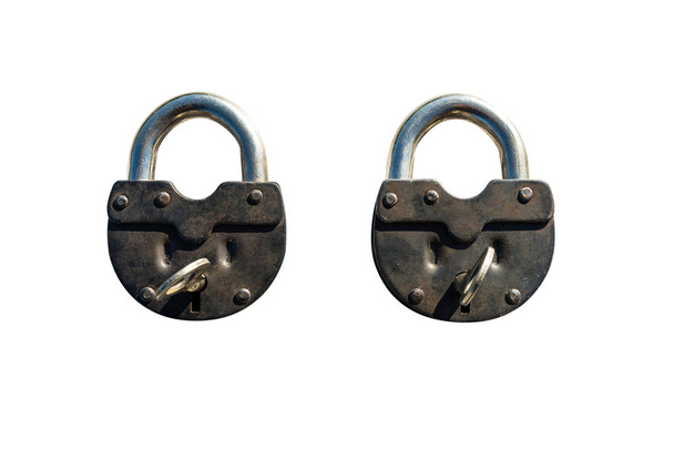 Two closed padlocks lying next to each other, isolated on a white background with a clipping path. - Photo, Image