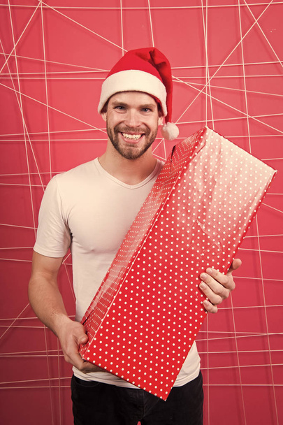 Man attractive santa claus carry big box. You deserve good gift. Christmas holiday celebration. Man handsome unshaven santa hat hold gift box. Christmas gift concept. Santa bring gift for you - Foto, immagini