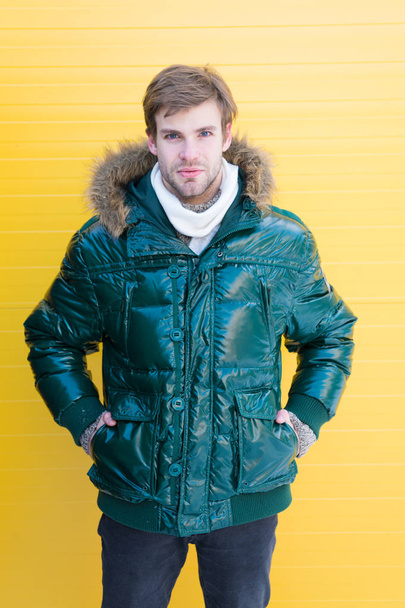 Improved protection for cold season. Fashion model enjoying warmth and comfort. Handsome man wearing hooded coat. Fashionable man in cold weather style. Casual fashion coat for cold winter conditions - Foto, imagen