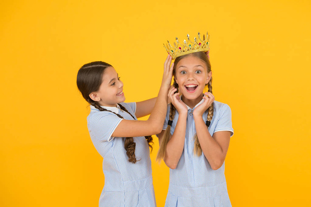 higher standard. vintage girls in gold crown. motivation to be the best. small egoist girls imagine they princess. success reward. happy childhood frienship. prom queen. retro look of selfish kids - Photo, image