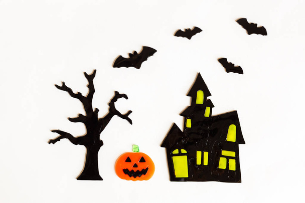 Top view of Halloween crafts, house, bat, tree on white background with copy space for text. halloween concept. Flat lay, overhead - Фото, изображение