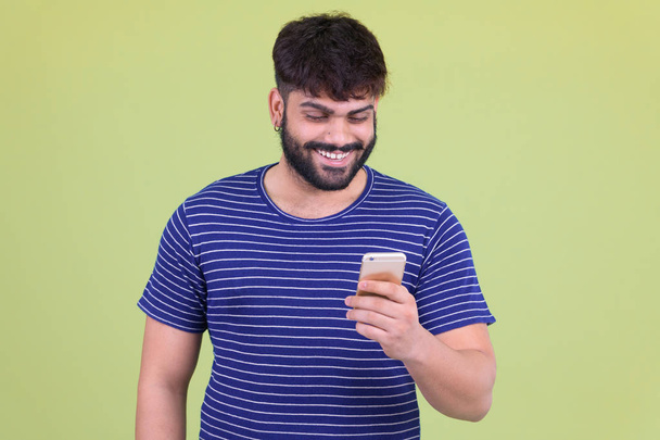 Χαρούμενος νέος υπέρβαρων Ινδικό άντρα χρησιμοποιώντας το τηλέφωνο - Φωτογραφία, εικόνα