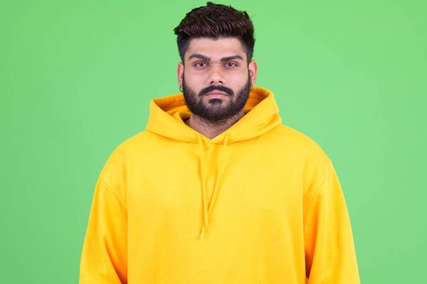 Young overweight bearded Indian man wearing hoodie - Photo, Image