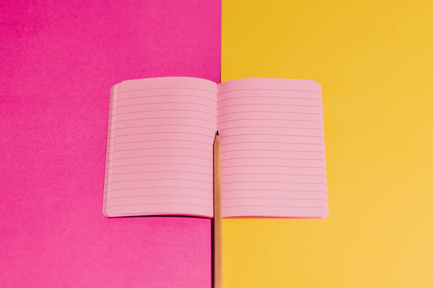 open notebook with blank pink pages on contrasting yellow and ma - Фото, зображення