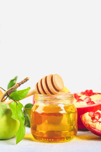 Rosh hashanah jewish New Year holiday concept. Traditional symbol. Apples, honey, pomegranate. - Photo, Image