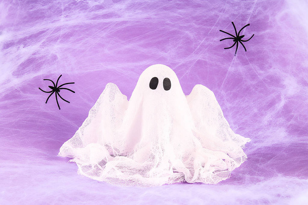 Halloween holiday concept. White spider web with two black spider web purple background. Diy ghost - Φωτογραφία, εικόνα