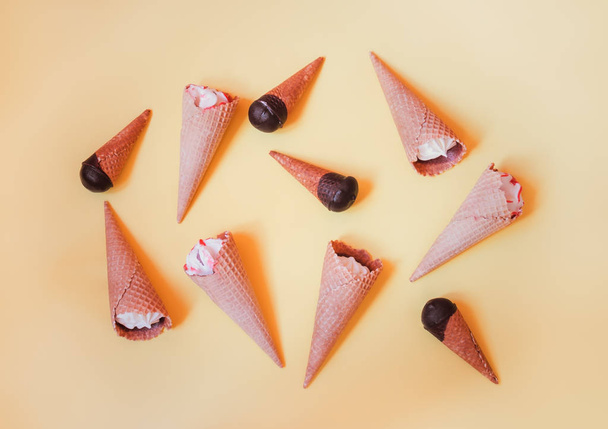 Food pattern made of different ice cream cones on yellow background. - Photo, Image