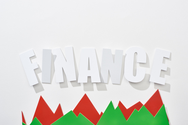 Draufsicht der Finanzinschrift mit grünen und roten Statistikgraphen auf weißem Hintergrund - Foto, Bild