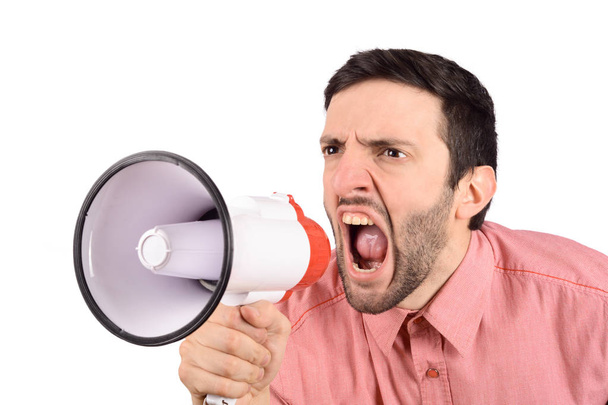 Young man screaming on a megaphone. - Foto, imagen