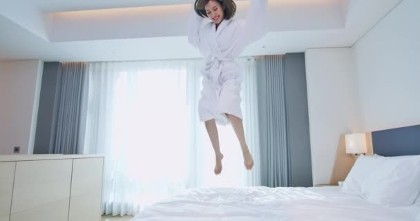 Excited woman jump with bathrobe - 映像、動画