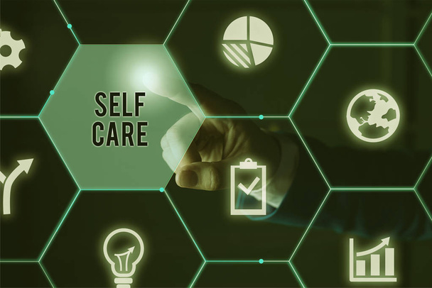 Text sign showing Self Care. Conceptual photo the practice of taking action to improve one s is own health Male human wear formal work suit presenting presentation using smart device. - Photo, Image