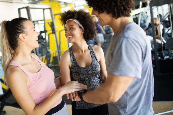 Picture of cheerful young fitness team in gym - Fotoğraf, Görsel