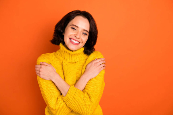 Photo of attractive beautiful nice cute charming trendy gorgeous casual girlfriend warmened with sweater feeling perfect while isolated with orange background - 写真・画像