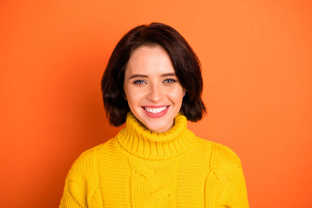 Photo of cute nice good friendly charming girl smiling with her white teeth while isolated with orange background - Foto, Imagen