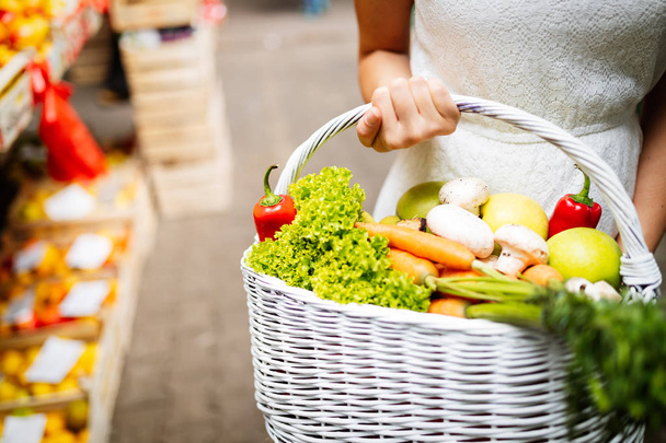 Young happy woman shopping healthy food on the market - 写真・画像