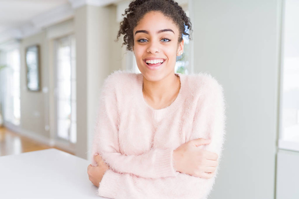 Beautiful young african american woman with afro hair happy face smiling with crossed arms looking at the camera. Positive person. - Foto, Bild
