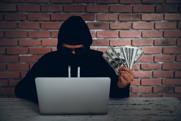 hacker try to hack and steal information system data from computer and show money after hacked it - Fotó, kép