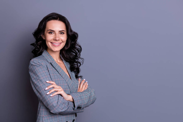 Turned photo of cheerful woman looking with her hands crossed wearing trendy blazer jacket isolated over greay background - Fotó, kép
