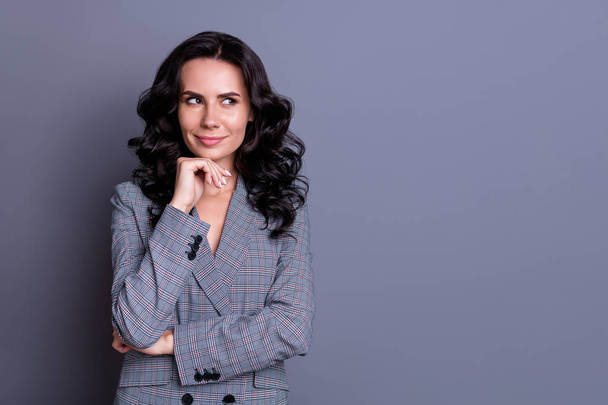 Portrait of charmign woman touching her chin looking at copyspace having thoughts wearing blazer jacket isolated over gray background - Valokuva, kuva