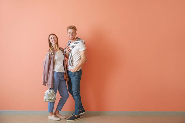 Couple in stylish t-shirts near color wall - Photo, Image