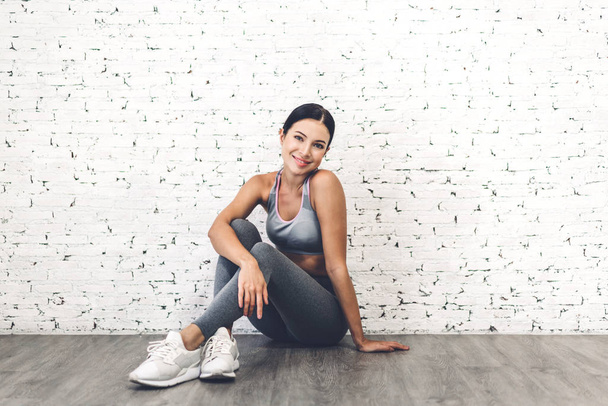 Sport woman in sportswear relax after workout against copy space - 写真・画像